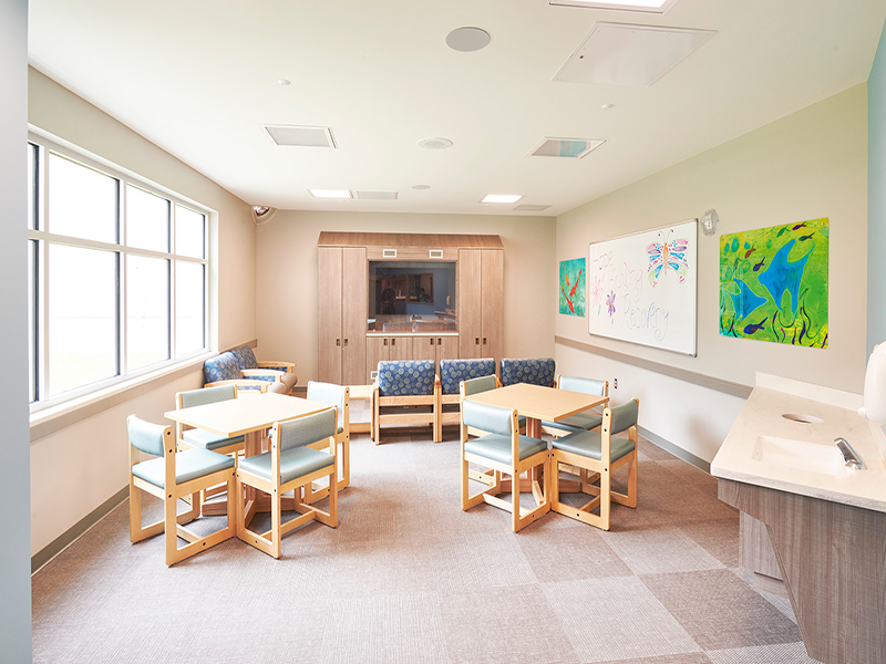 Tables and chairs in a children's activity room at Tower Behavioral Health