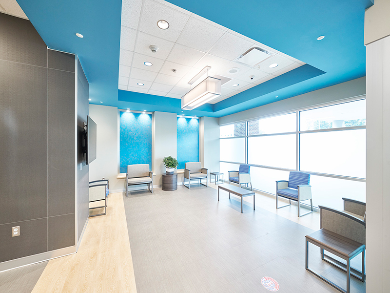 A waiting room with table and chairs at Tower Behavioral Health